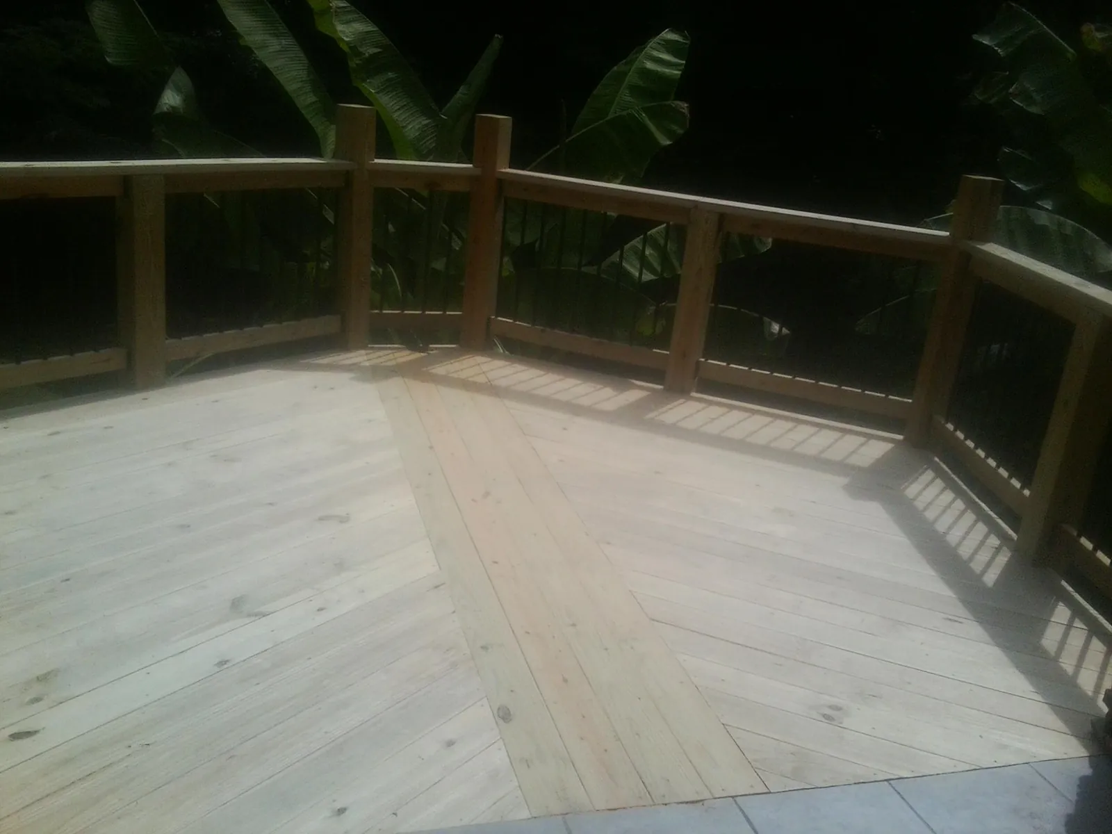 New wood deck and railing built off the back of a home in Lebanon